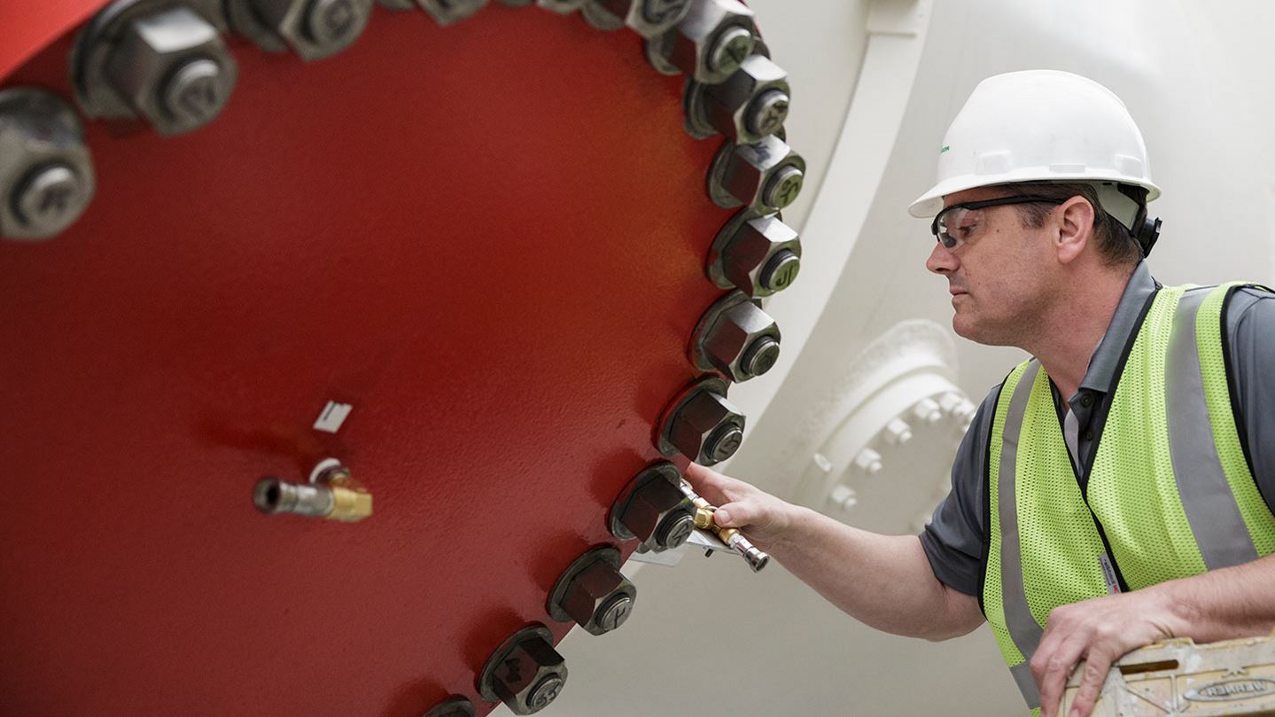 Technician inspecting part of an LNG coil wound heat exchanger 